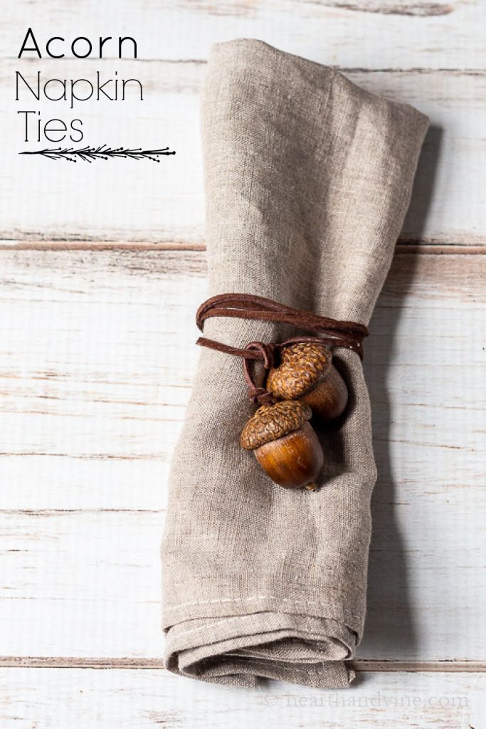 Acorn napkin tie in brown cording wrapped around a linen napkin.