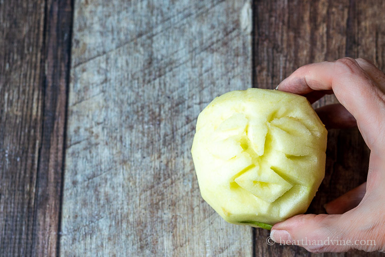 Peeled apple carved into a face.