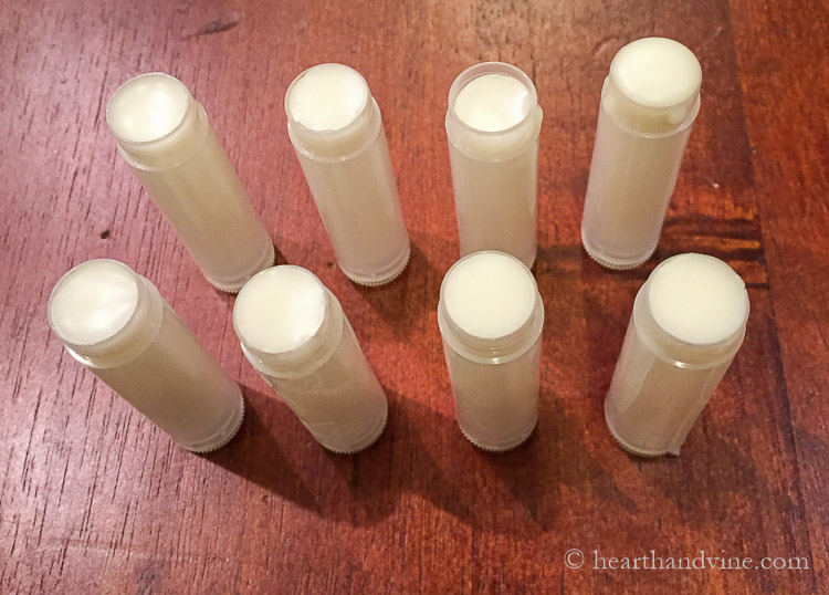 Filled tubes of homemade lip balm on the table.