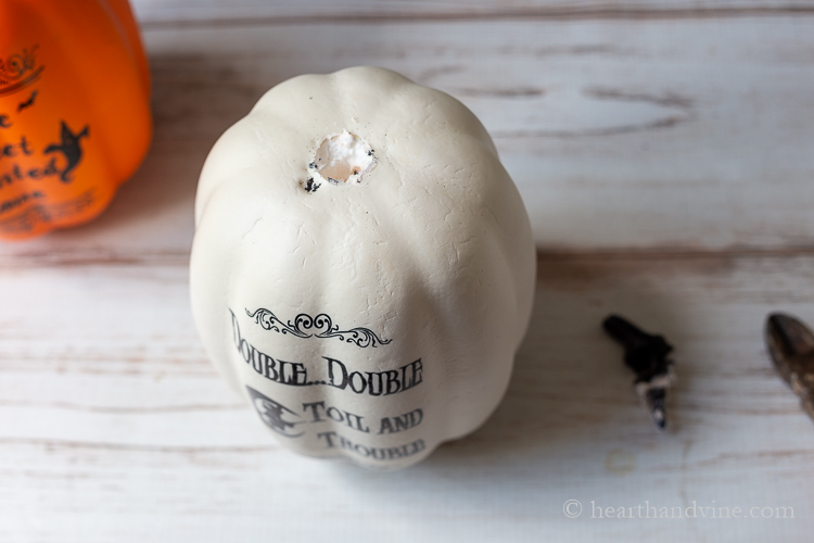 White foam craft pumpkin with the stem removed.