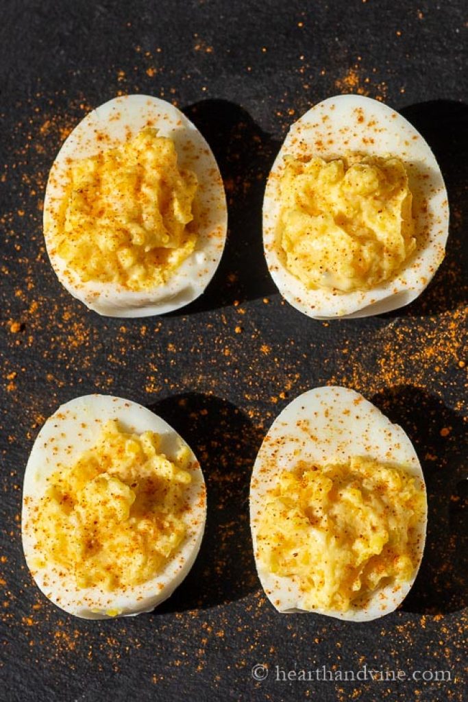 Deviled eggs on a black tray.
