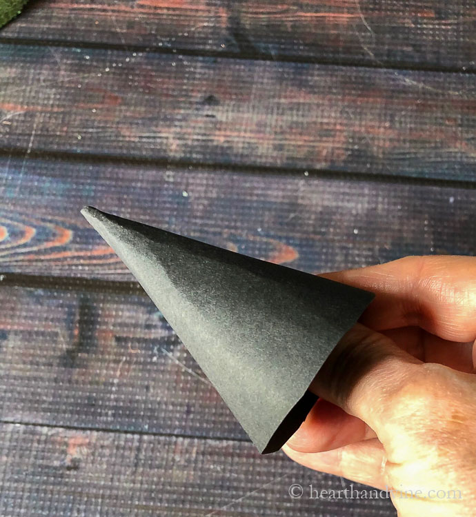 Black card stock folded into a cone shape.