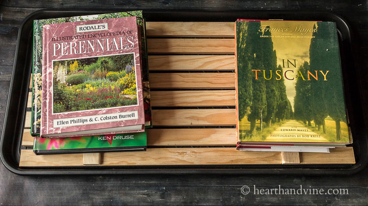 Books on top of wood slat boot tray.