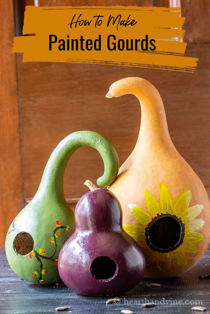 Three painted gourds on a table.