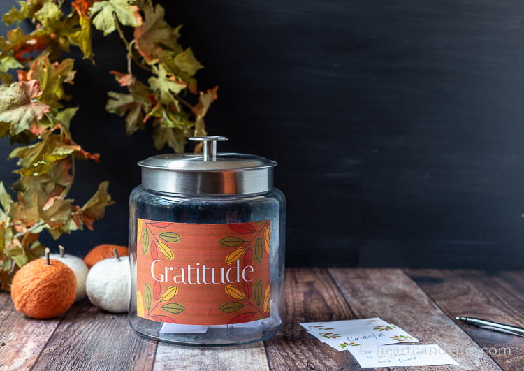 Gratitude jar for Thanksgiving with pumpkins fall leaves and cards.