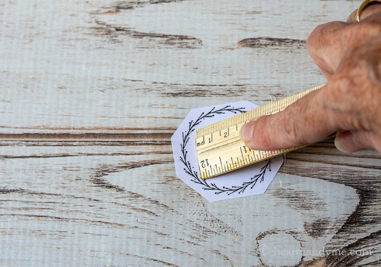 Rubbing the packing tape onto the paper graphic.