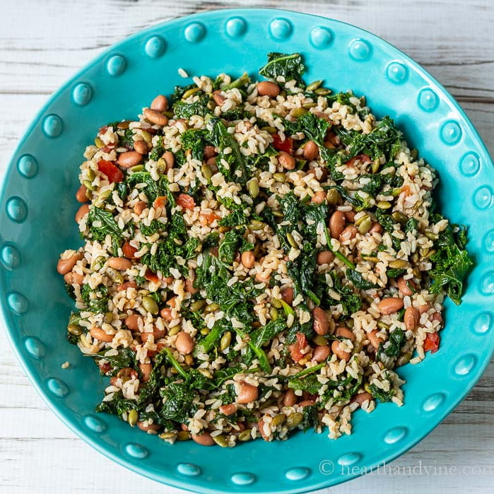 Large blue bowl of greens and grains