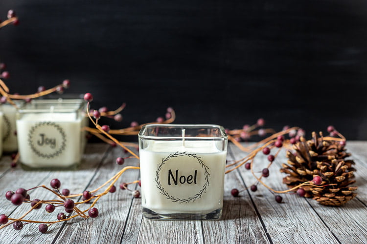 Noel candle with faux red berries and pine cones.