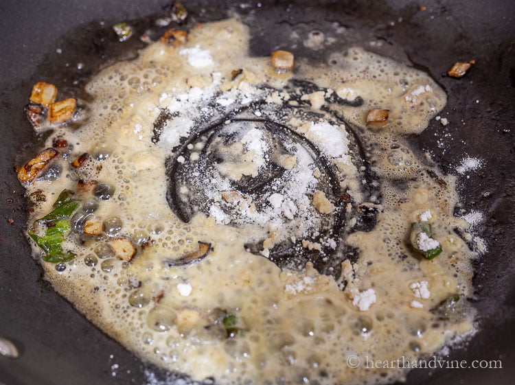 Making a roux with pan drippings butter, and flour.