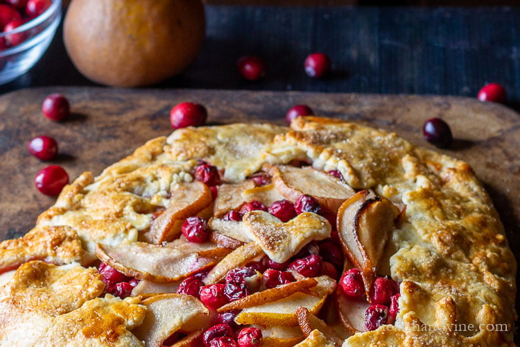 Easy rustic pear cranberry galette on a pizza stone.