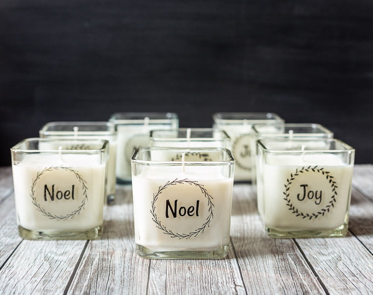 Square glass candleholders with Joy and Noel wreath packing tape labels.