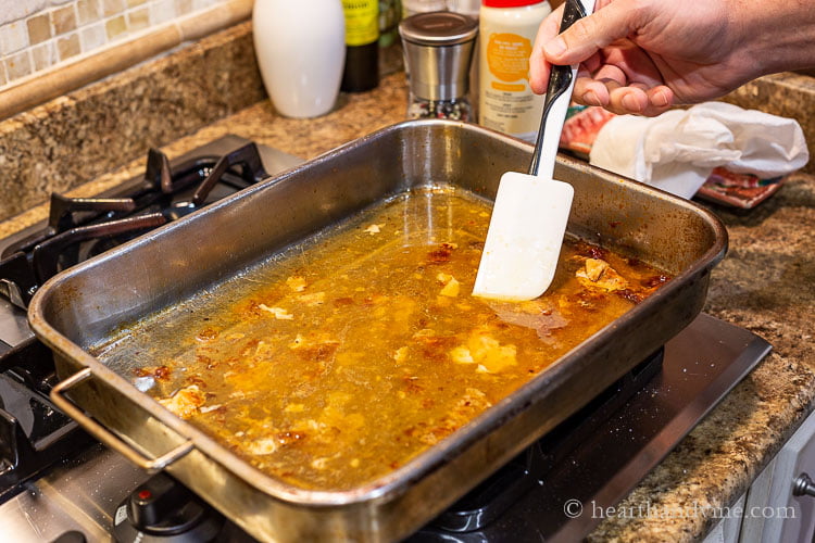 Deglazing a pan after the roast was removed on the stove with a spatula.