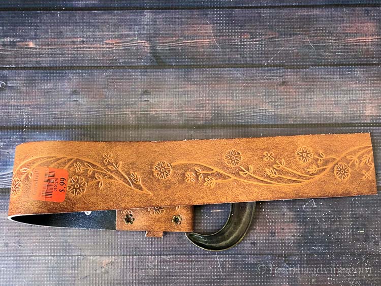 Old thrift store belt with flowers etched into it.