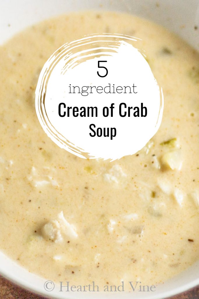 White bowl with cream of crab soup and a text overlay stating 5 ingredient cream of crab soup.