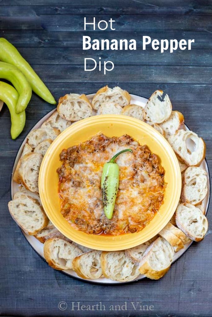 Hot banana pepper dip with sliced bread around the side.