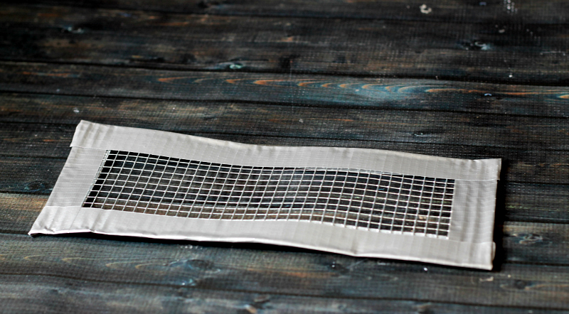 Wire mesh strip with duct tape covering edges.