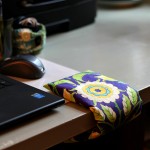 Wrist comfort cuff on desk next to laptop.