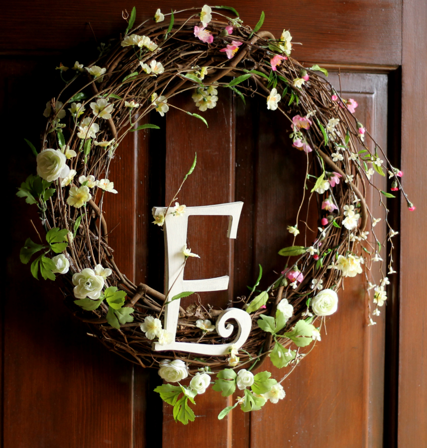 Spring grapevine wreath with spring blossoms and a monogram letter E in the center.