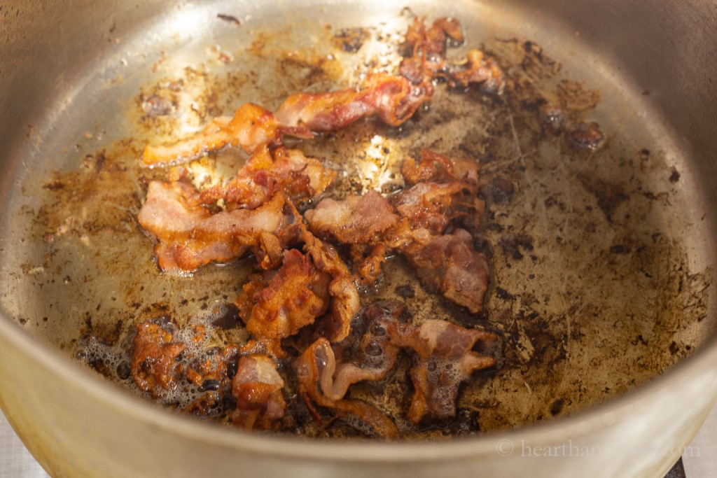Bacon cooking in a heavy pot.