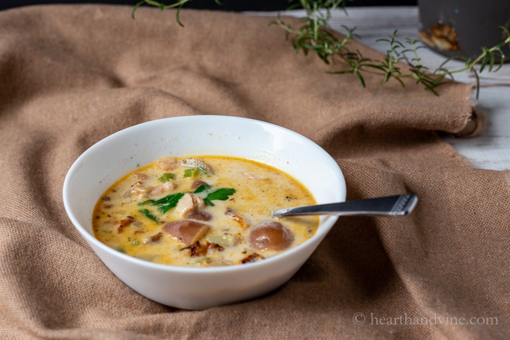 Bowl of New England clam chowder with a spoon.