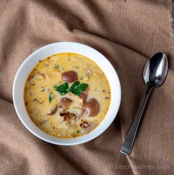 Bowl of New England chowder on a brown cloth.