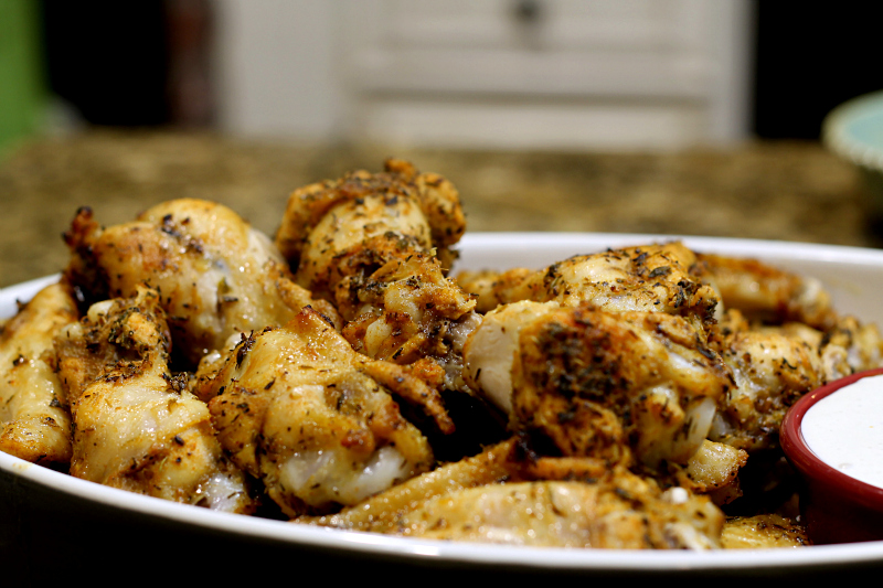 Close up of baked wings in a serving bowl.