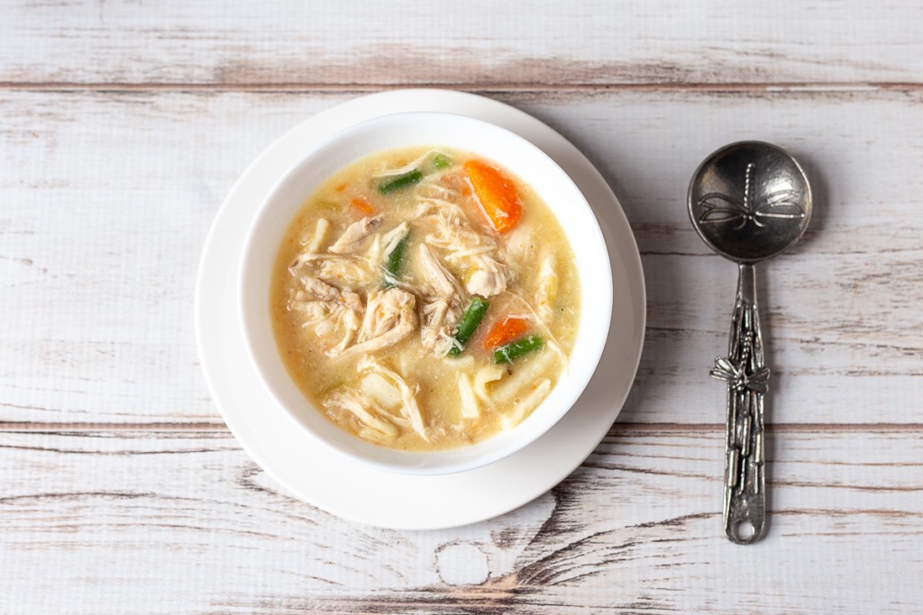 Bowl of chicken pot pie without crust and homemade noodles.