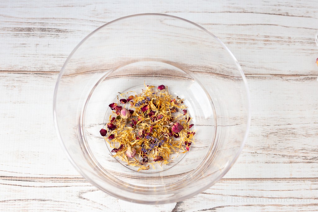 Large clear bowl with rose petals, calendula petals and lavender buds.