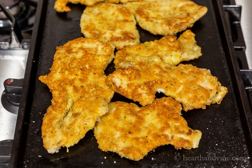 Breaded chicken breasts fried in olive oil until golden brown.