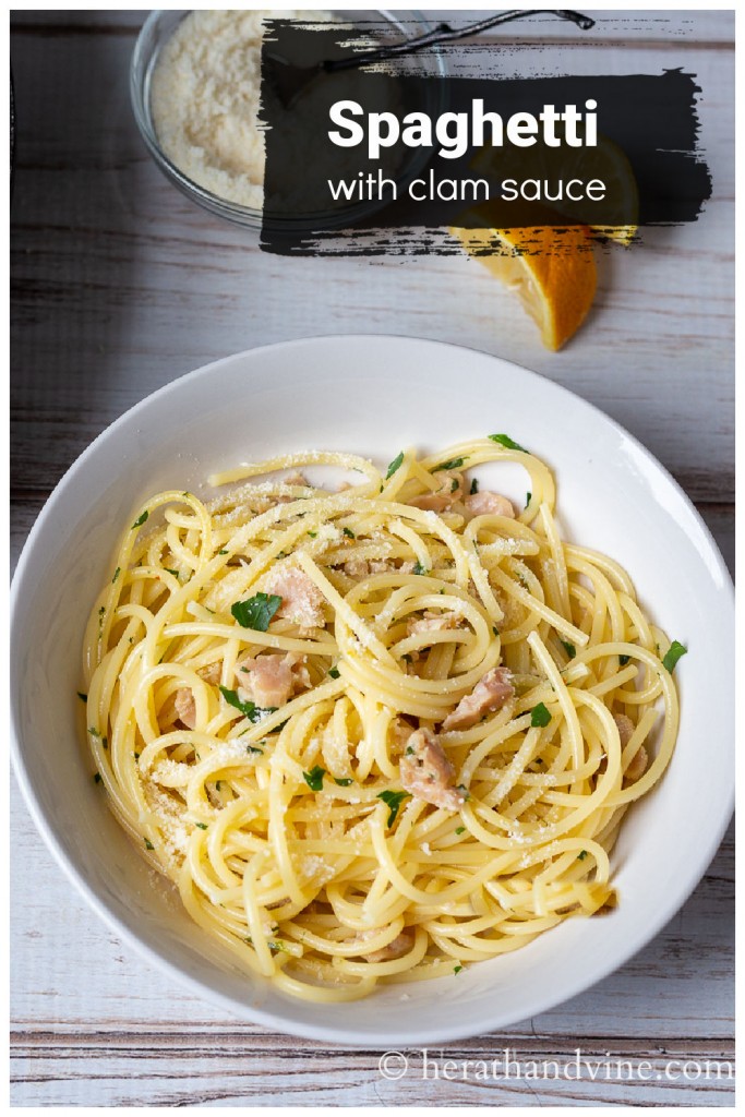 A white bowl of spaghetti with clam sauce.