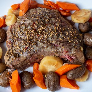 Roast corned beef with potatoes, carrots and parsnips