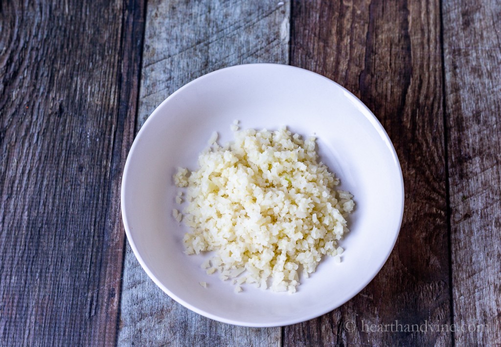 Cauliflower rice in a white bowl.