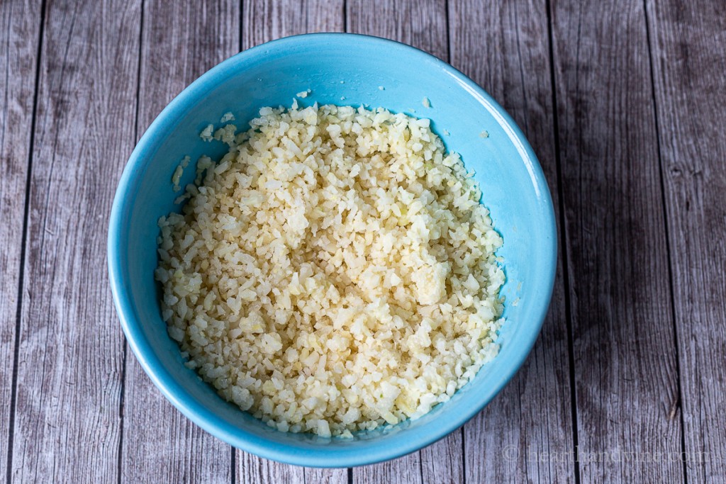 Cauliflower rice in a blue bowl.
