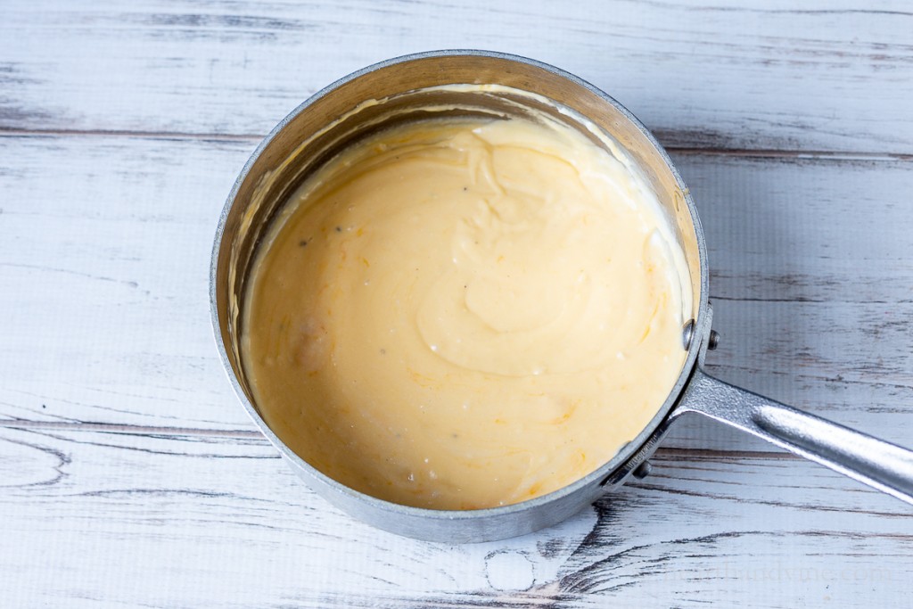 Creamy cheese sauce in a saucepan.
