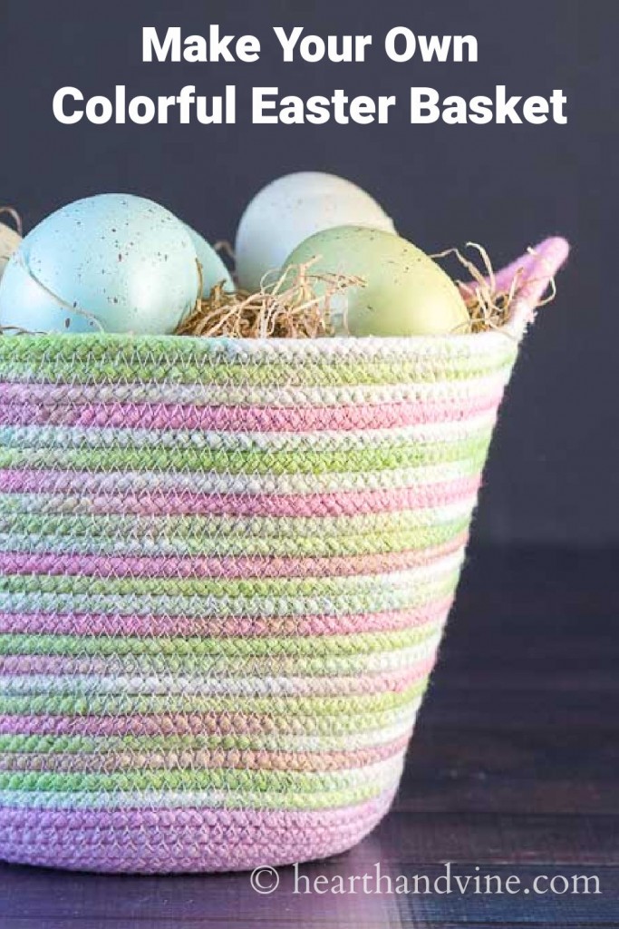 Pastel colored rope basket with faux straw and Easter eggs.