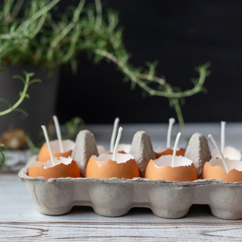 Eggshell candles in cardboard container.