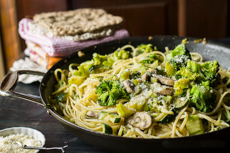 SKillet of pasta primavera with spaghetti, broccoli, mushrooms and zucchini.