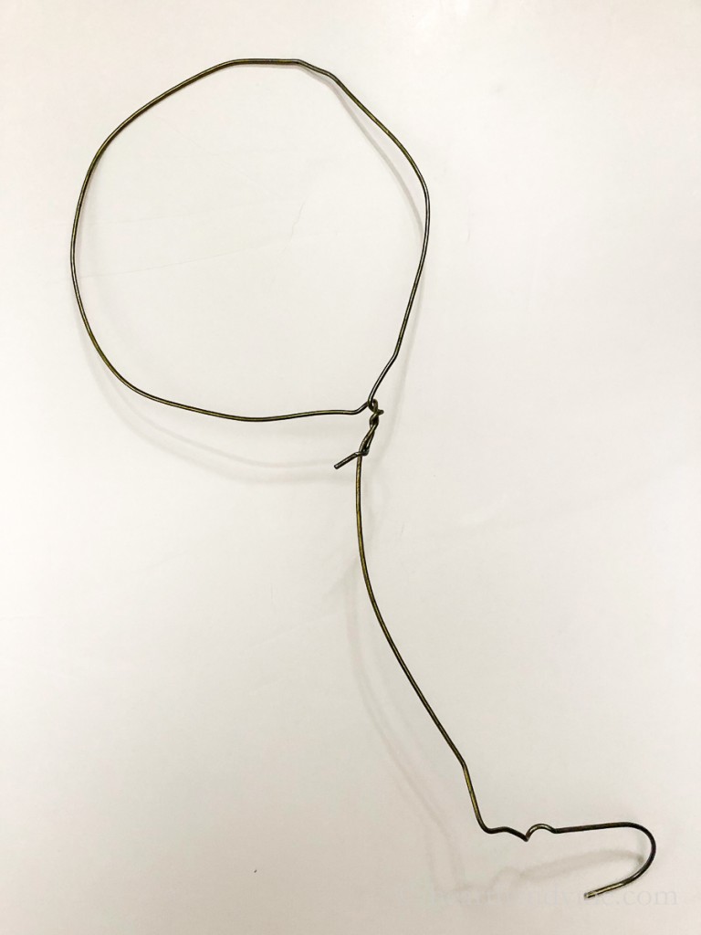 Wire hanger twisted into a round shape on top.