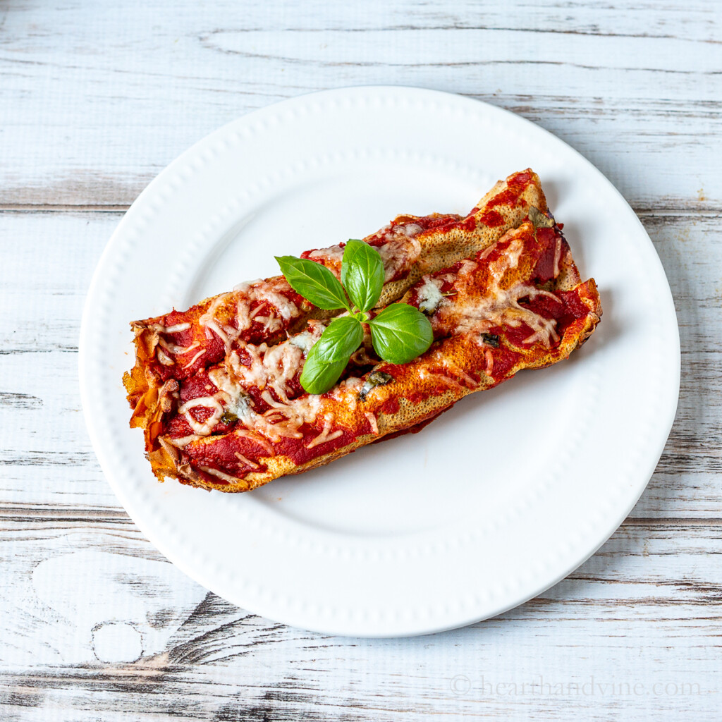 Three cannelloni on a plate.