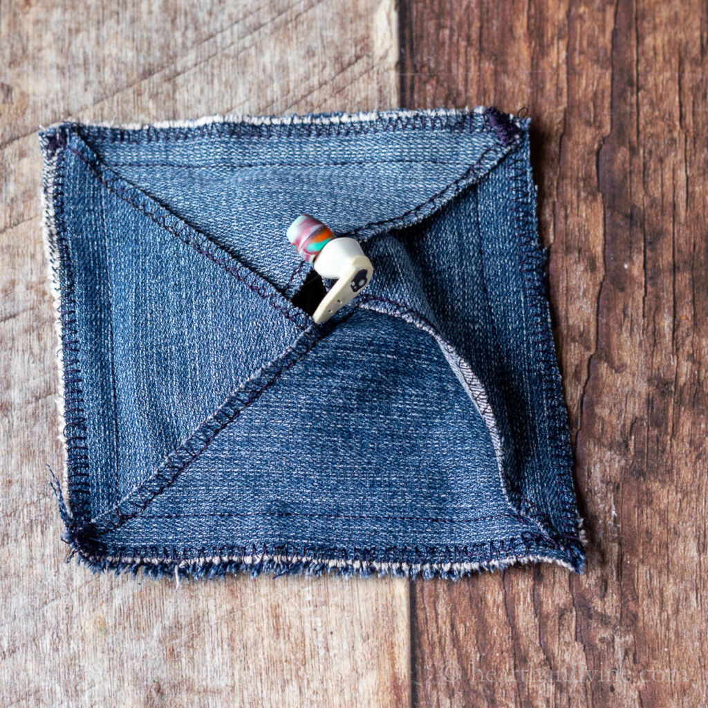 Denim pouch with earbuds inside