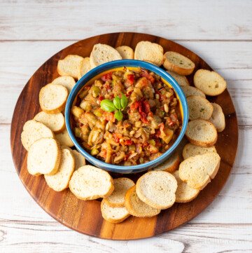 Roasted eggplant caponata surrounded by bread rounds