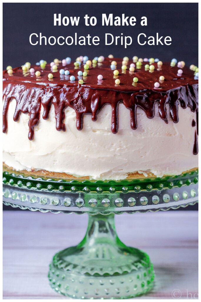 Close up of a layer cake with white icing and a chocolate drip top with pastel nonpareils for Easter.