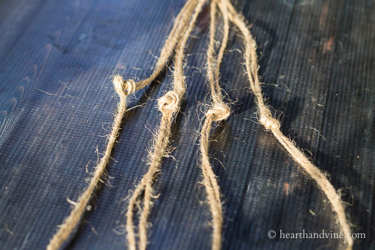 Groups of two lengths of twine tied in knots about half way down.