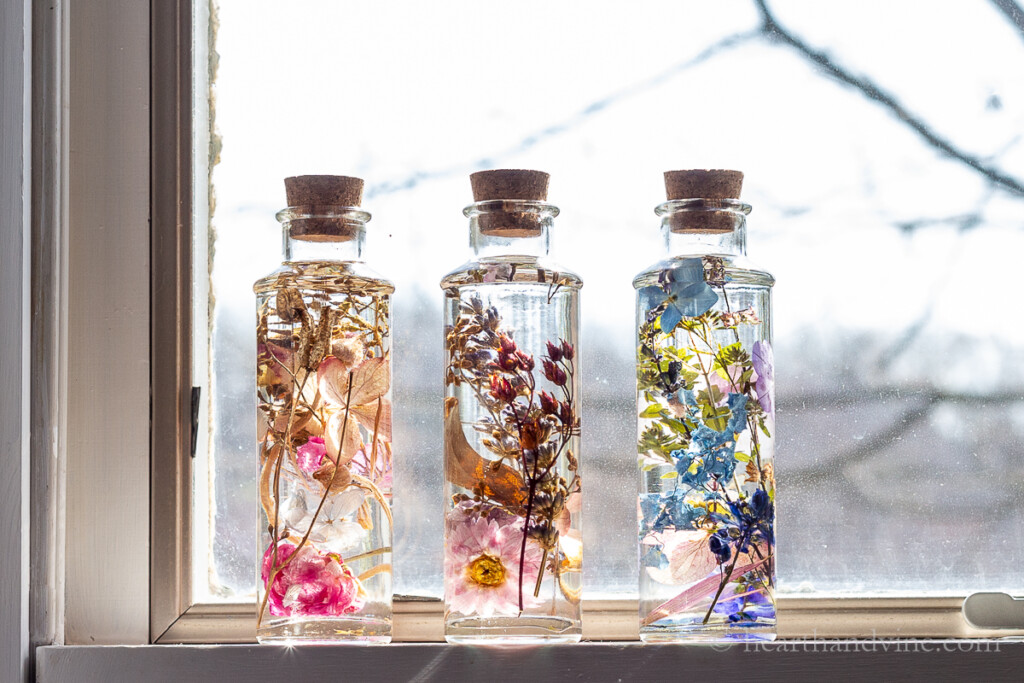 Three Japanese Herbarium bottles on a windowsill.