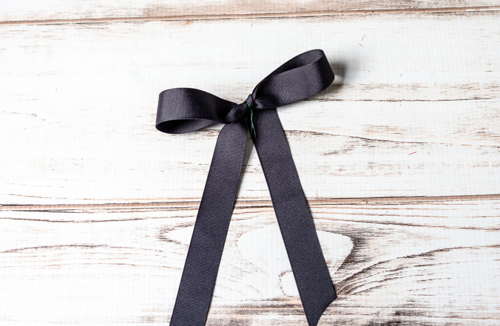 Black grosgrain ribbon made into a bow with wire.