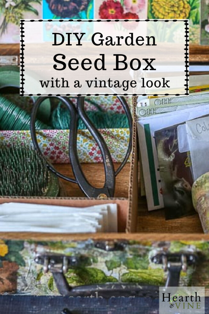 The inside of a wooden seed box with garden shears, seed packets and floral wire.