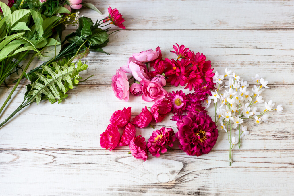 Artificial flower tops dark pink colors and a few white stems.