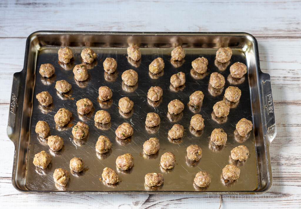Mini Italian meatballs on a baking tray.