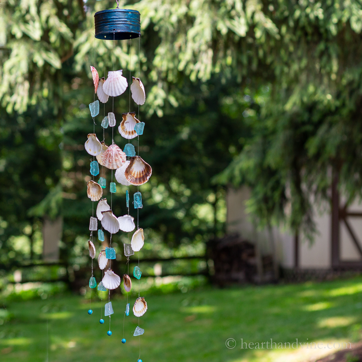 Sea glass and seashell wind chimes hanging outside.