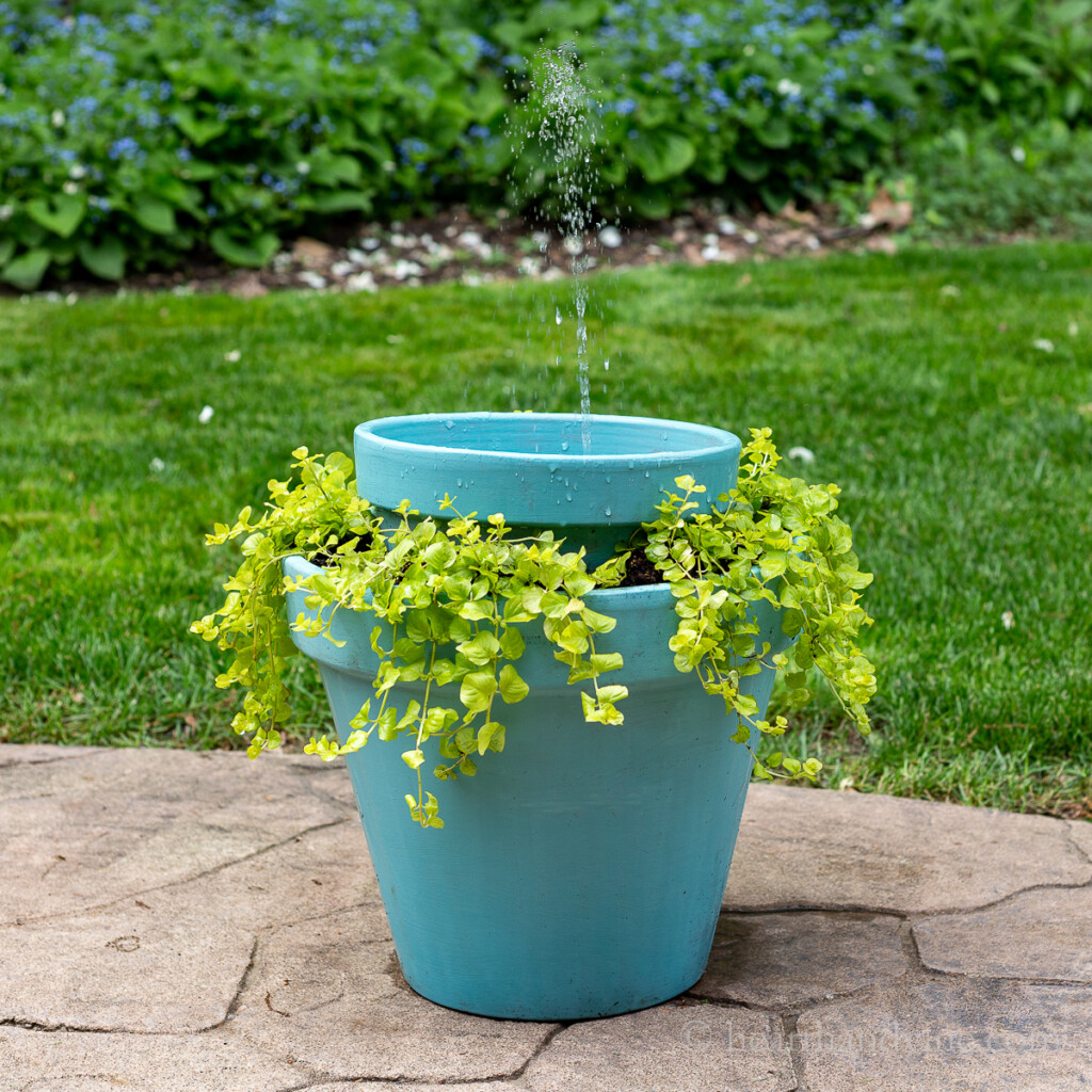 Homemade solar water fountain that doubles as a planter from clay pots.